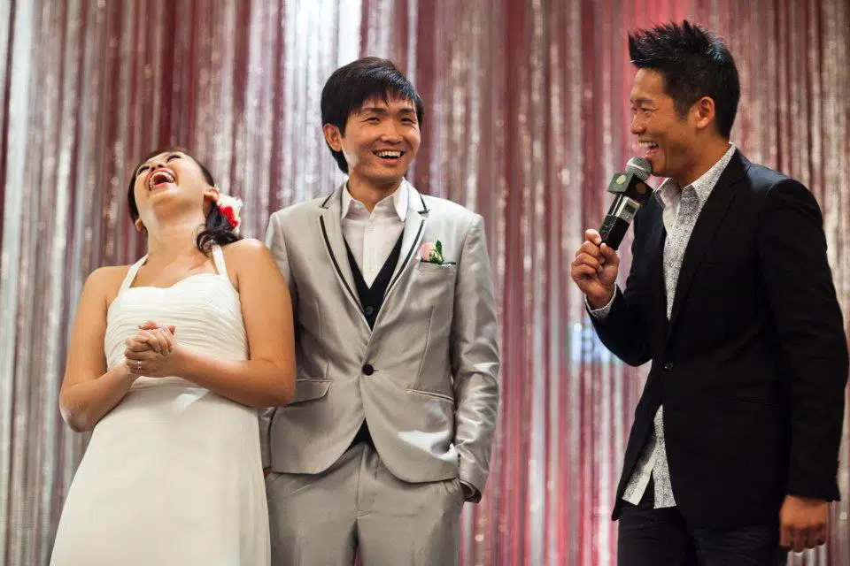 James Yang engaging a guest during a wedding banquet