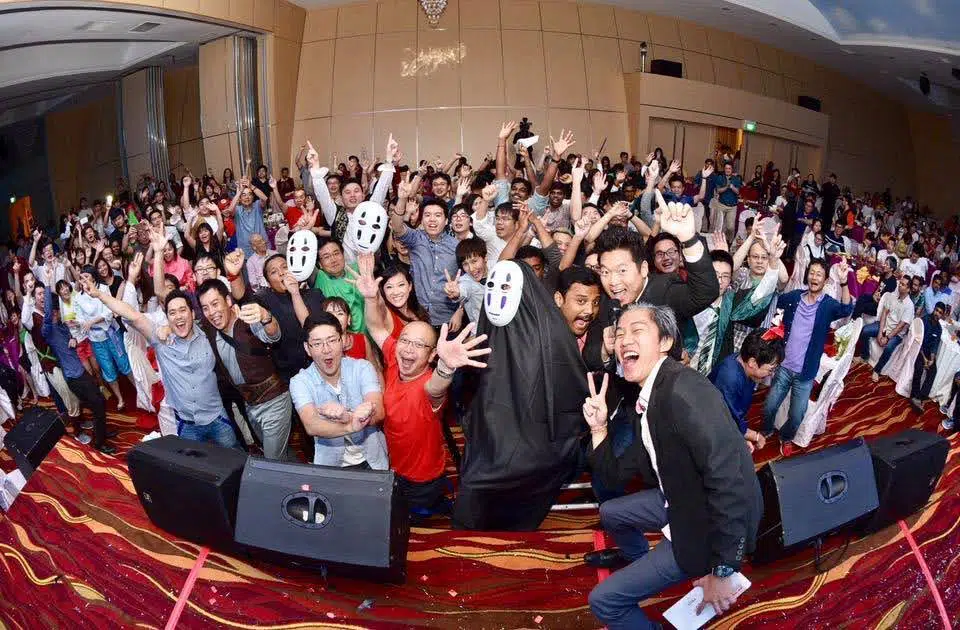 James Yang with a full ballroom crowd at a live event